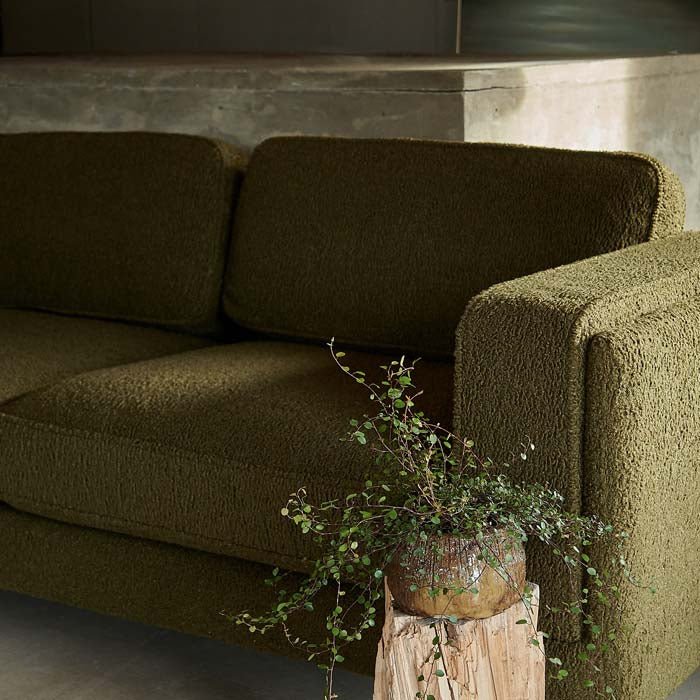 Khaki green boucle fabric on three seater sofa.