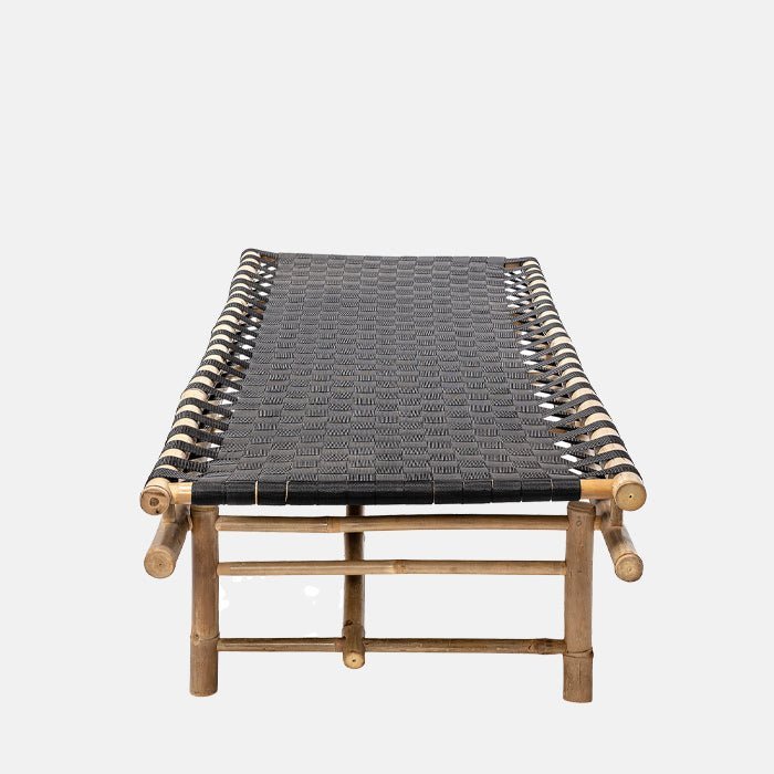 A cutout of the Levada Daybed. A bamboo outdoor daybed with black top pictured lengthways.