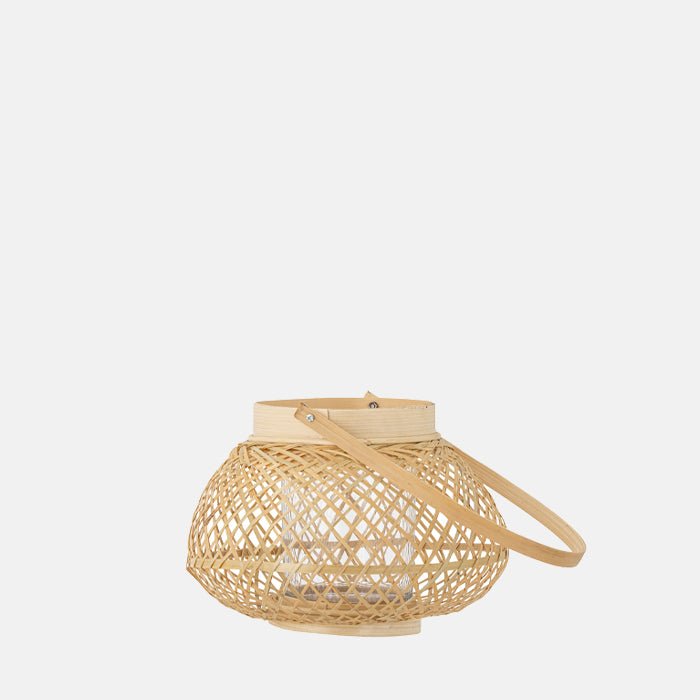 Cutout on a white background of a woven bamboo lantern without a candle in it.