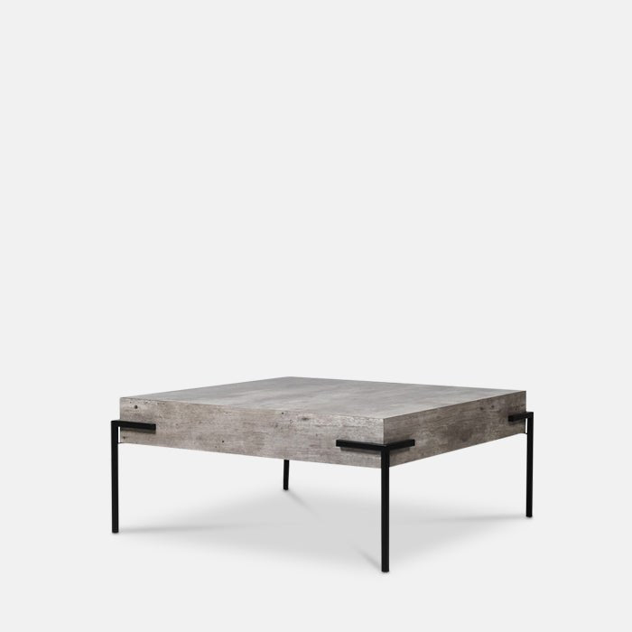 Faux concrete square coffee table with four black metal legs.