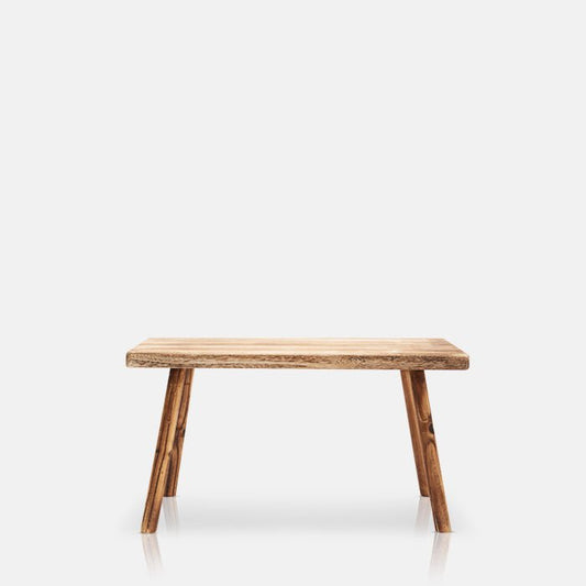 A cutout photo of a wooden bench in light wood with four legs. Homeware from Abigail Ahern with fuss free returns.