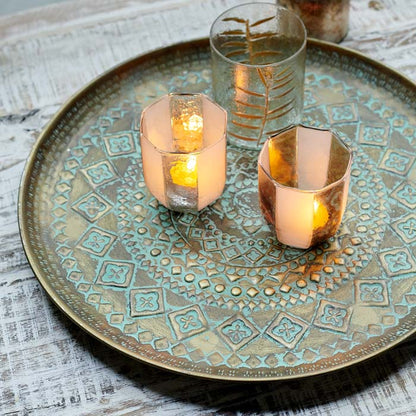 Bronze, decorative tray with glass tea light holders on top.