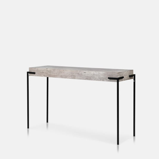 Slim console table with faux-concrete table top and four black metal legs.
