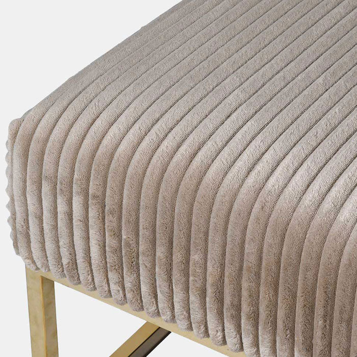 Close up of the Andover Ottoman. A square coffee table upholstered in a soft brown corduroy velvet with a brass colour frame.