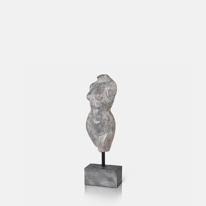A cutout of the Aphrodite Scultpure, a polyresin model of a female torso with a faux metal finish mounted on a small plinth. 