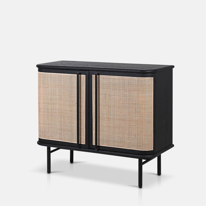 Black wooden cabinet with woven rattan style doors and long handles
