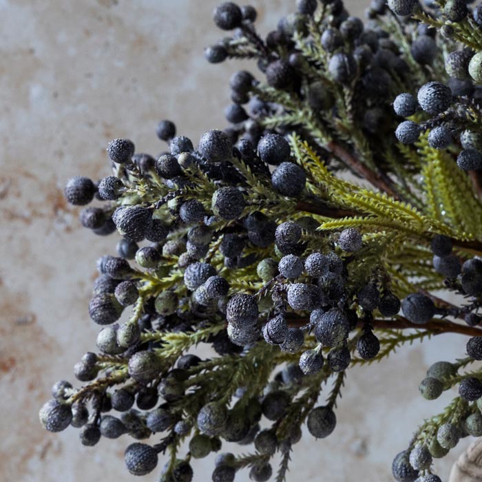 Detail image of the abundant dark blue faux berries on some artificial brunia berry stems.