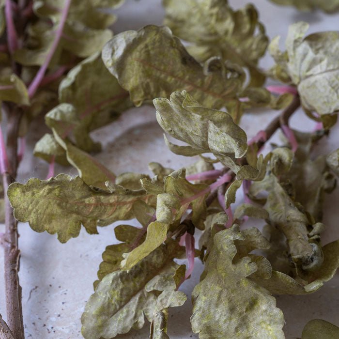 Detail image of the curling leaves on a stem of artificial ragwort.