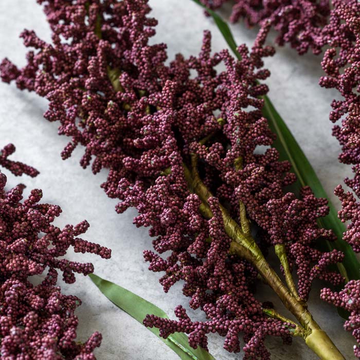 A few stems of artificial wetland heirloom's dark pink textural heads.