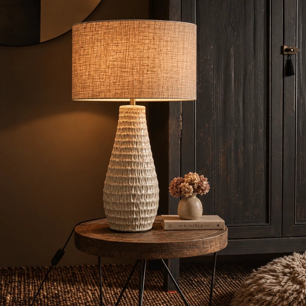 Aspal Cream Table Lamp with rounded cream ceramic base and pale shade, styled on a console table in a warm neutral interior with decorative accessories.