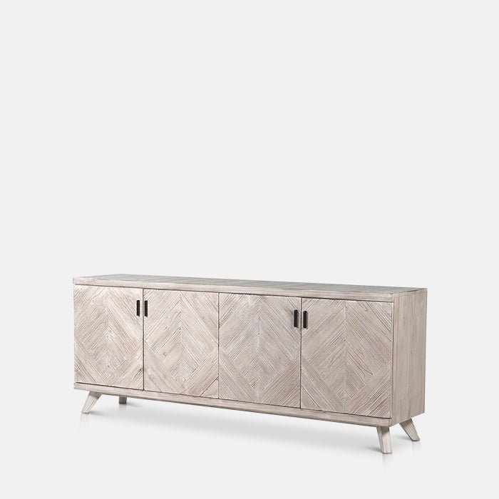 A cutout of the Astor Console Table, a sideboard with 4 doors and 12 shelves in a herringbone wooden tiled pattern.