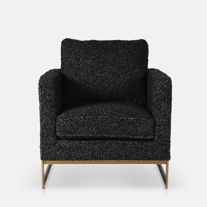 Grey boucle armchair with a gold frame on its base