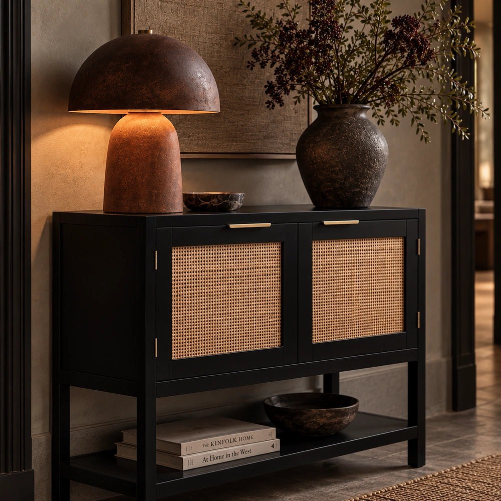 Bailey Black Wood Cabinet with dark textured finish and geometric doors, styled in a warm contemporary living room with neutral decorative accessories.
