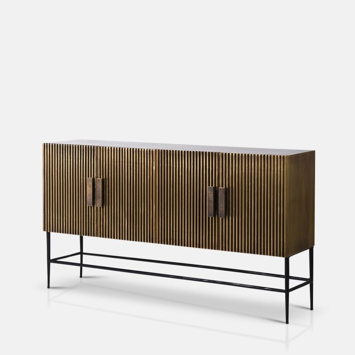 Long gold sideboard with ribbed doors and a black metal frame Abigail Ahern Banbury Sideboard in antique brass with a warm metallic gold finish, streamlined rectangular shape and generous enclosed storage.