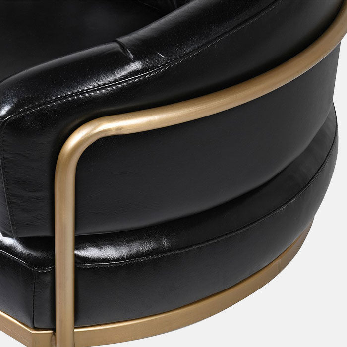 Golden frame wrapped around curved black leather cushioning