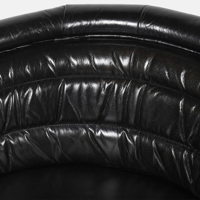 Natural creases in the curved black leather cushioning