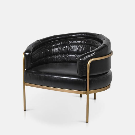 Curved black leather armchair with a golden metal frame