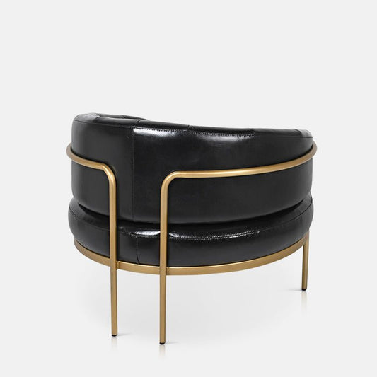 Curved gold frame and black leather back of a chair