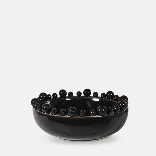 Large glossy black decorative bowl with different sized balls around its edge