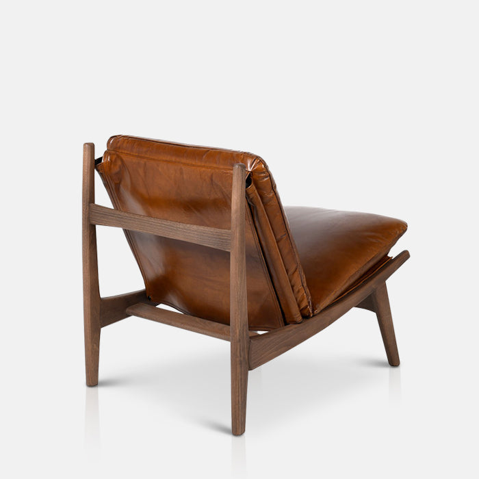 Dark wooden frame of an armchair with brown leather cushioning