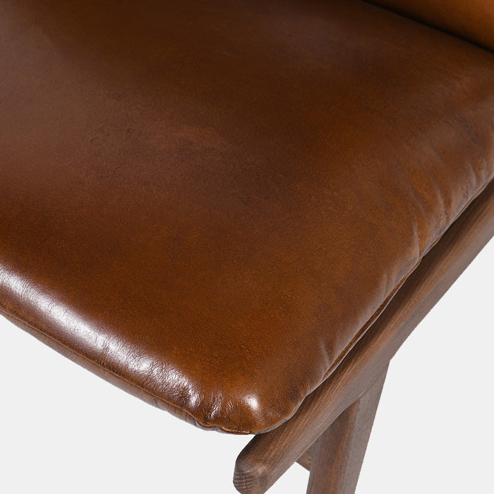 Dark brown leather cushioning sat on a wooden frame