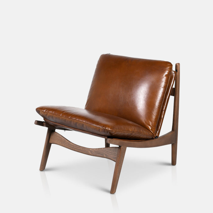 Dark brown leather cushioning on a wooden armchair