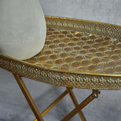 Patterned cutout details on golden tray table top with foldable gold trays