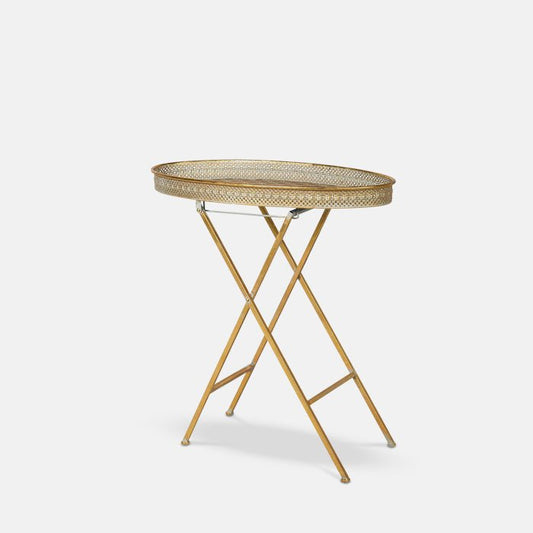 Foldable gold metal side table with decorative cutout pattern on table top.