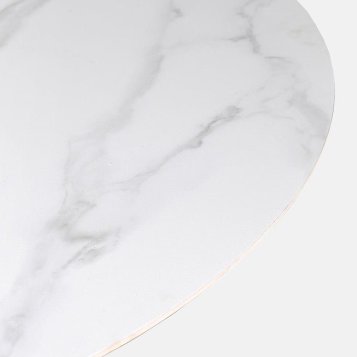 A close up of the Caldwell Dining Table. A round faux carrara marble top on a chunky black metal base table.