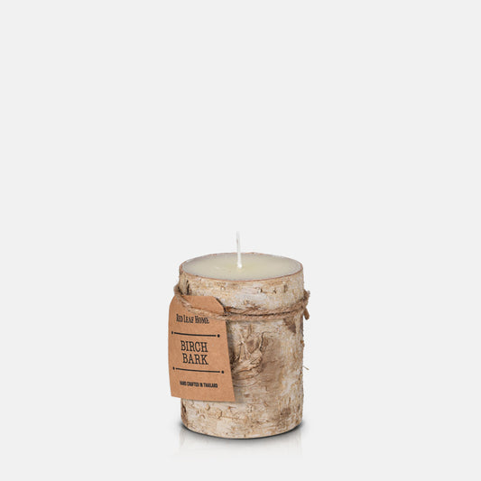 A bark covered life-like candle with a brown label.