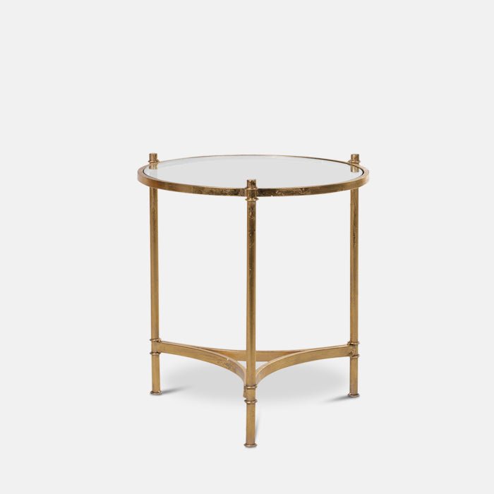 Round glass side table with gold metal frame.