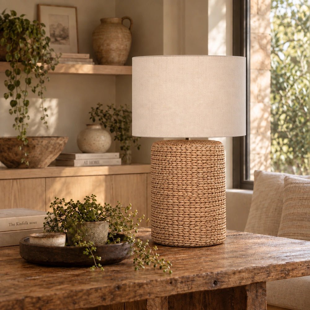Celano Rope Table Lamp displayed on a styled console, with its sculptural textured base and shade arranged alongside decorative objects in a warm interior.