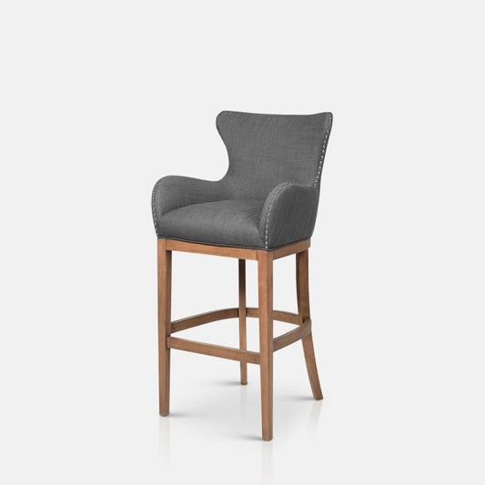 High backed grey bar stool on wooden legs with studded details
