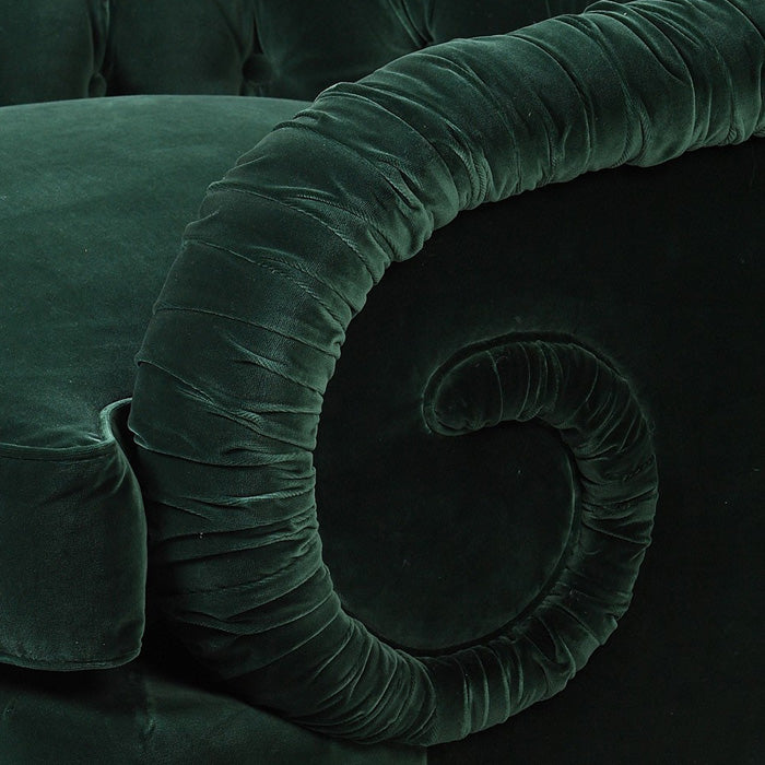 Rouched green velvet spiral on the arm of an armchair