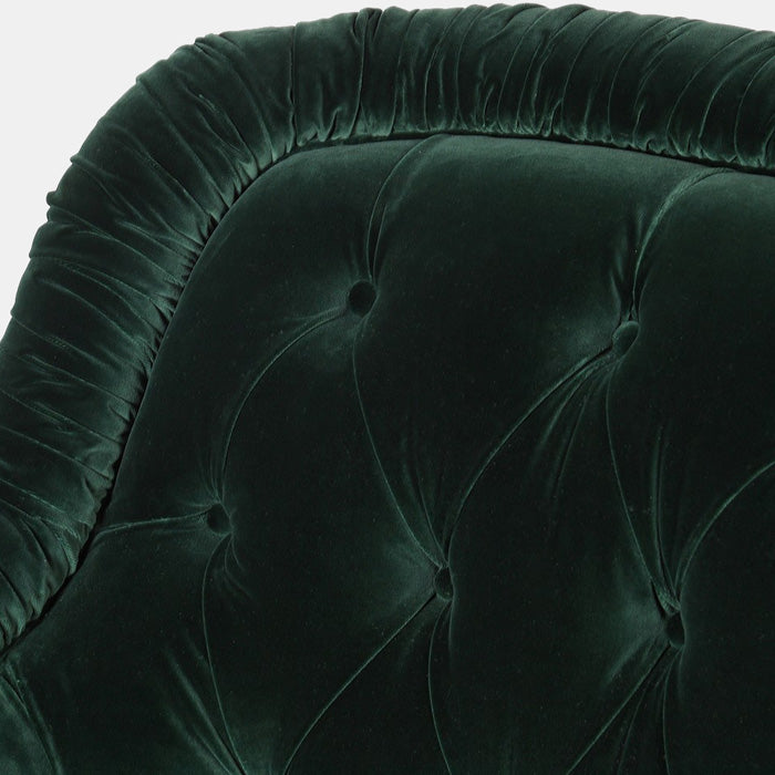 Green velvet armchair with a rouched edge and pressed button cushioning