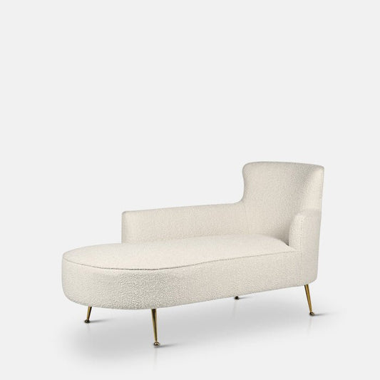 Long cream chaise longue with a high back sat on four golden legs