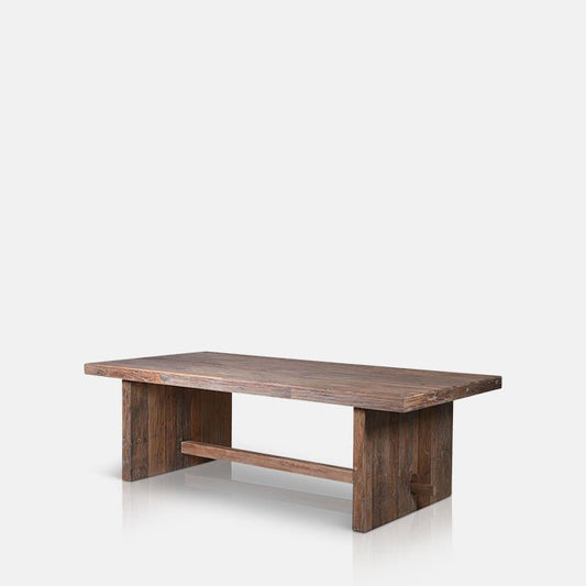 Large rectangular dining table sat on two wooden legs held together with a wooden beam