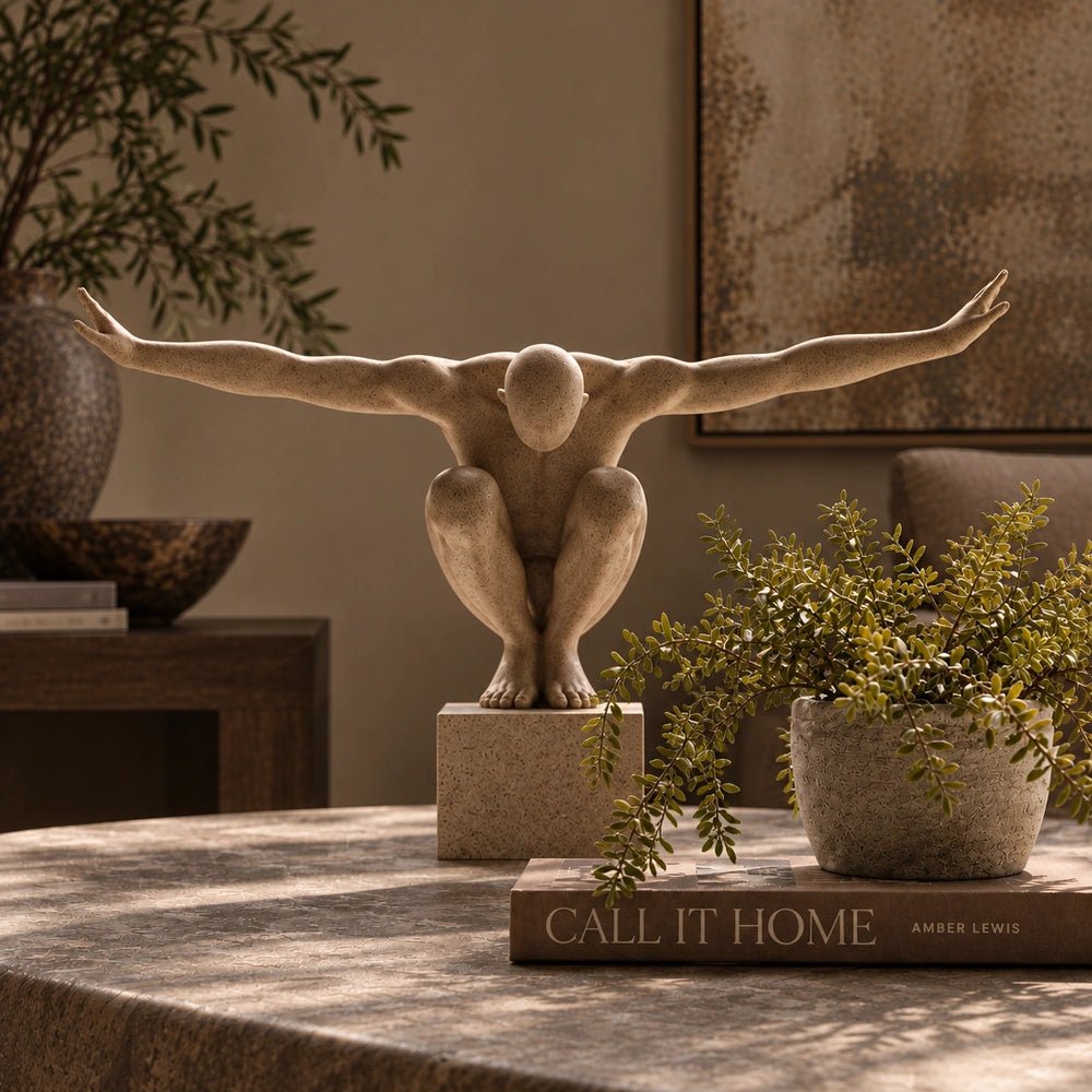 Croyde Figurative Sculpture displayed in a styled table arrangement, with its sculptural human form surrounded by decorative objects in a warm interior setting.