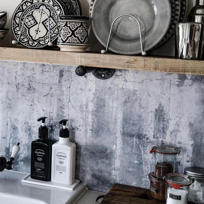 Concrete effect vinyl backsplash stickers placed behind a kitchen sink