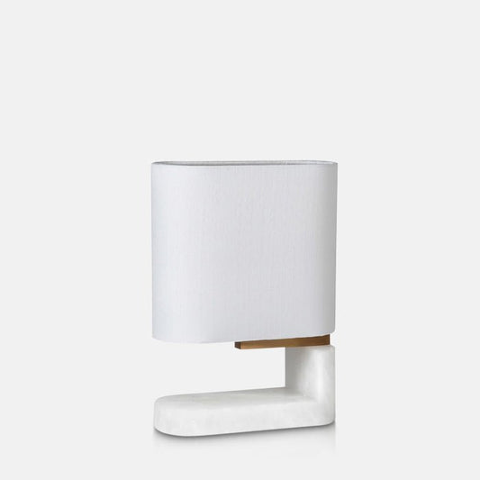 White alabaster L-shaped table lamp with white shade.