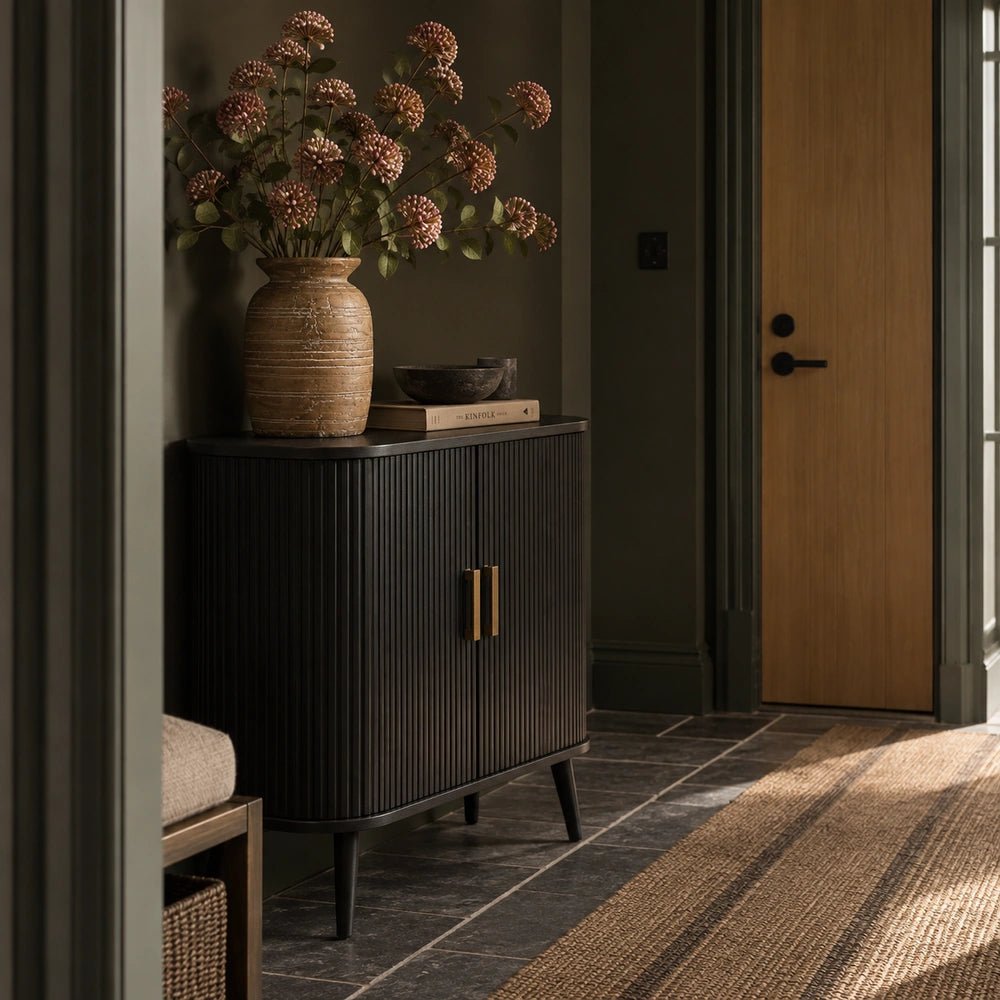 Dolton Wooden Cabinet styled in a warm neutral interior with sculptural ceramics, stacked books and a textured table lamp, highlighting its dark wood finish.