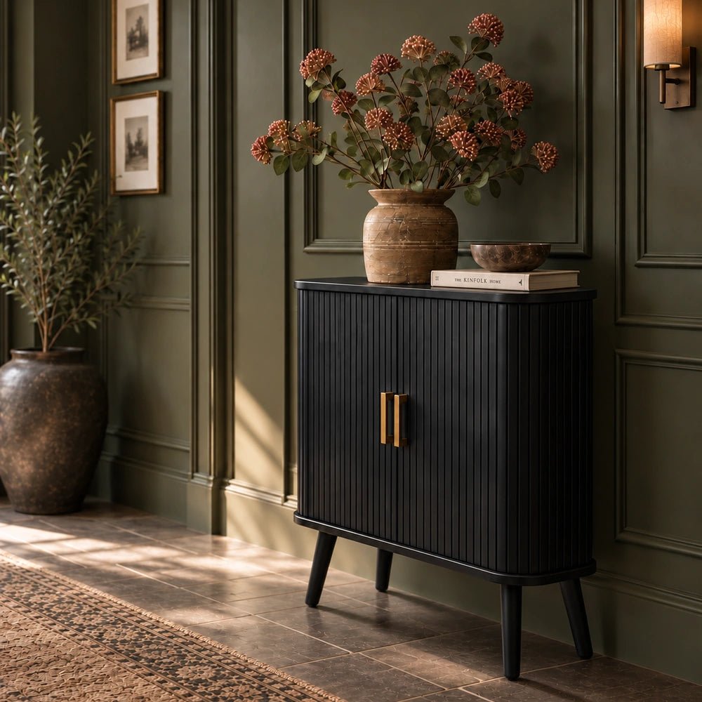 Dolton Wooden Cabinet with dark textured wood finish and geometric paneled doors, styled with lamps, artwork and decorative objects in a warm living room.