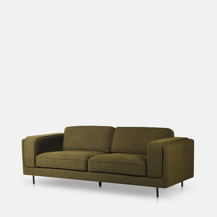 A large three seater boucle sofa in an army green, with 5 black legs.