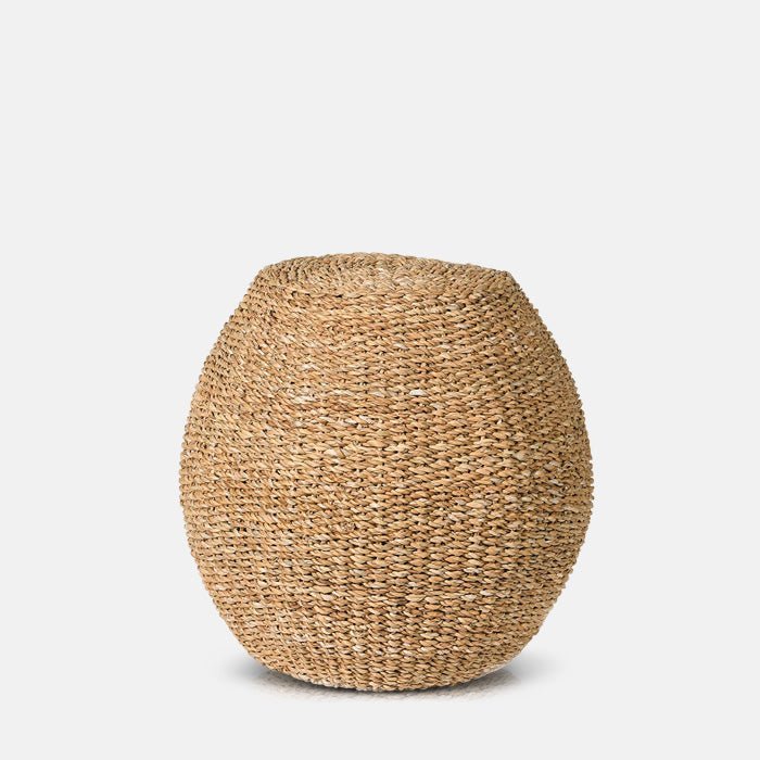 A cutout of the Elias Seagrass Stool, a tall woven seagrass stool in a round shape.
