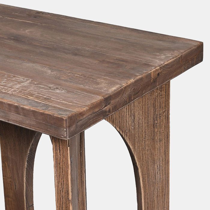 The Epping Console Table, a slim rectangular table in recalimed elm with an elaborate circular cutout shaped base.