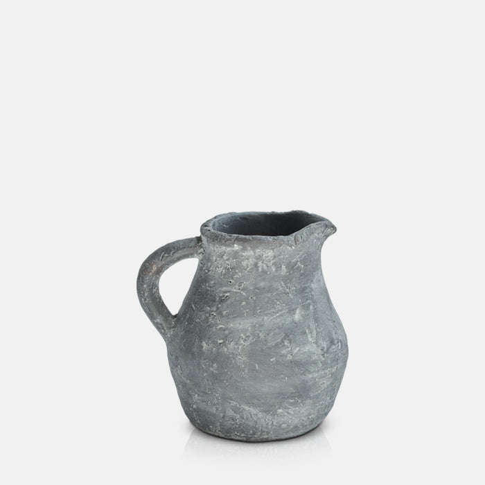 Rustic grey cement vase in the shape of a jug.