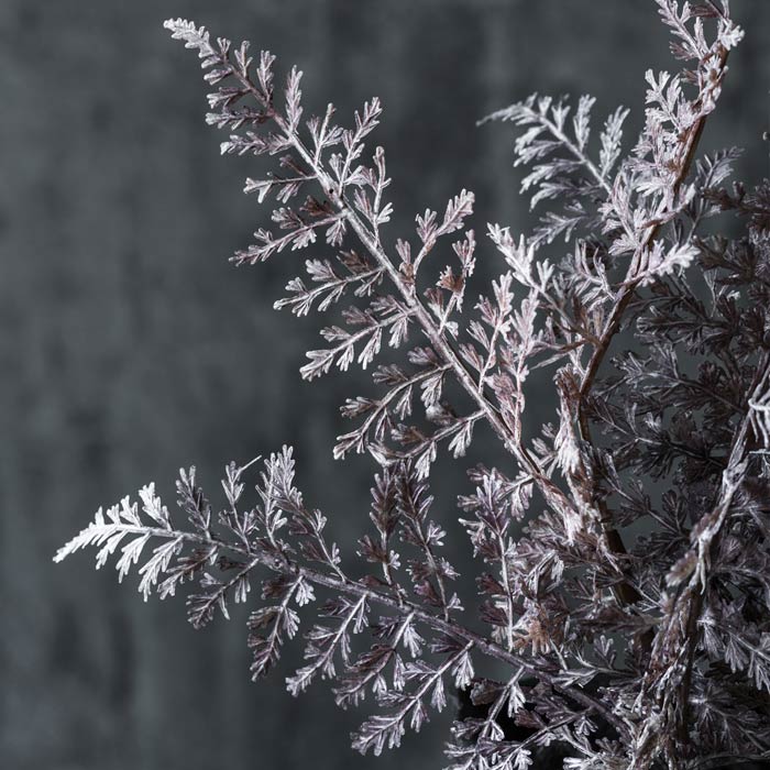 Silvery purple fronds on an artificial fern stem.