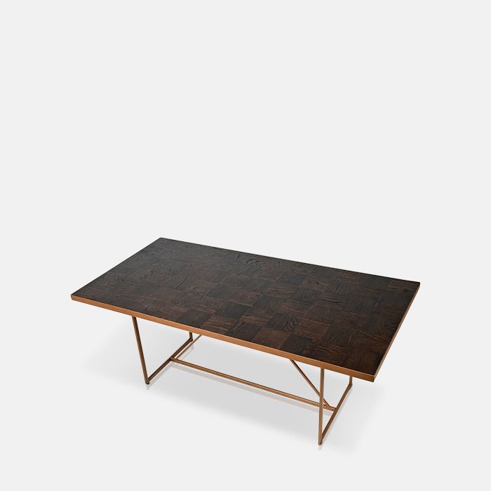 Parquet topped dining table in a rectangular shape with a gold metal frame