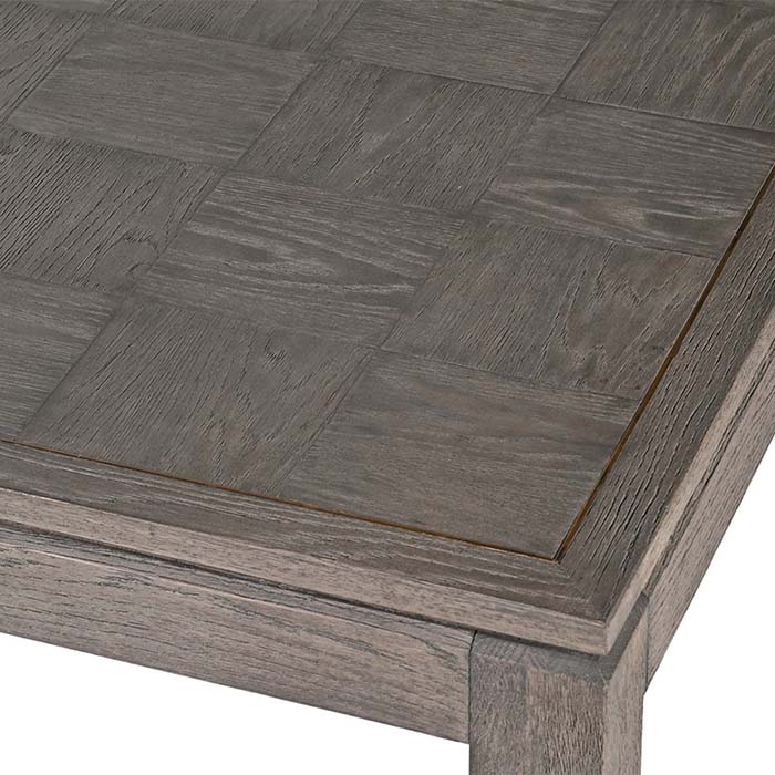 A closeup of the oak veneer parquet style surface on the Frances Dining Table.