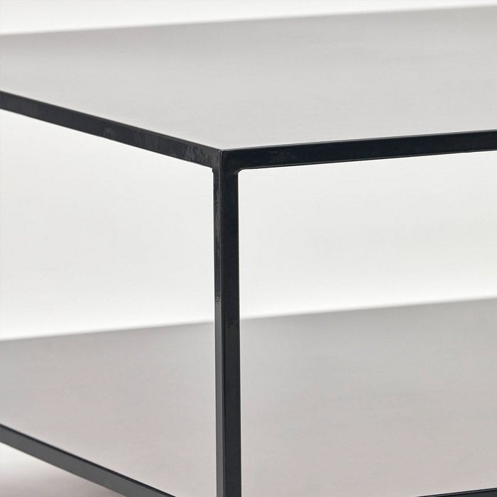 A corner of a square metal coffee table with black finish.